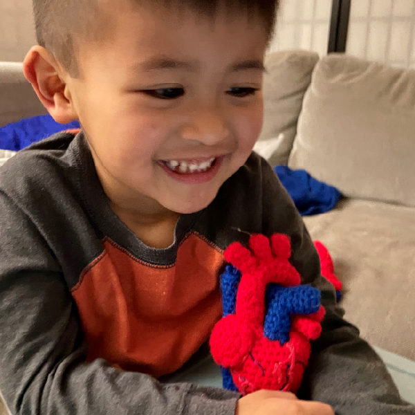 Youung boy with crocheted heart